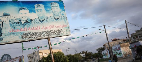 A Palestinian vehicle drives through a roundabout past a billboard bearing the portraits of Mohammed Abu Shamala (R) and Raed al-Attar (C), commanders of Hamas' armed wing al-Qassam Brigades, in Rafah in the southern Gaza Strip on January 19, 2018 A Palestinian vehicle drives through a roundabout past a billboard bearing the portraits of Mohammed Abu Shamala (R) and Raed al-Attar (C), commanders of Hamas' armed wing al-Qassam Brigades, in Rafah in the southern Gaza Strip on January 19, 2018 - Sputnik International