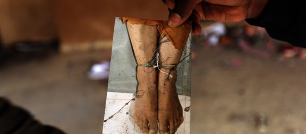 A Libyan protester shows a picture found in the ransacked headquarters of the judiciary police in Benghazi. (File) A Libyan protester shows a picture found in the ransacked headquarters of the judiciary police in Benghazi. (File) - Sputnik International
