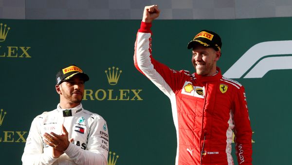 Formula One F1 - Australian Grand Prix - Melbourne Grand Prix Circuit, Melbourne, Australia - March 25, 2018 Ferrari's Sebastian Vettel celebrates his win on the podium with Mercedes' Lewis Hamilton - Sputnik International