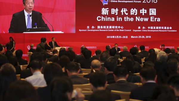 China's Central Bank Governor Yi Gang delivers a speech at the China Development Forum at the Diaoyutai State Guesthouse in Beijing, Sunday, March 25, 2018 - Sputnik International