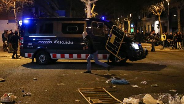 A protestor throws a barrier at a Catalan police van during skirmishes after former regional president Carles Puigdemont was detained in Germany, at a demonstration in Barcelona, Spain March 25, 2018. A protestor throws a barrier at a Catalan police van during skirmishes after former regional president Carles Puigdemont was detained in Germany, at a demonstration in Barcelona, Spain March 25, 2018. - Sputnik International