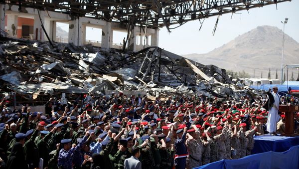 Army officers allied with the Houthis attend a rally at a parade square damaged by air strikes to mark the third anniversary of the Saudi-led intervention in the Yemeni conflict in Sanaa, Yemen March 26, 2018 - Sputnik International