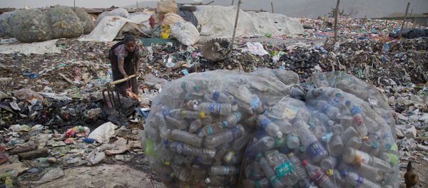 An Indian woman makes a drain for dirty water to pass next to plastic bottles collected for recycling at a garbage dumping site in Gauhati, India, Wednesday, Mar 7, 2018 An Indian woman makes a drain for dirty water to pass next to plastic bottles collected for recycling at a garbage dumping site in Gauhati, India, Wednesday, Mar 7, 2018 - Sputnik International