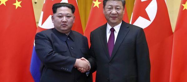 In this photo provided Wednesday, March 28, 2018, by China's Xinhua News Agency, North Korean leader Kim Jong Un, left, and Chinese President Xi Jinping shake hands in Beijing, China. In this photo provided Wednesday, March 28, 2018, by China's Xinhua News Agency, North Korean leader Kim Jong Un, left, and Chinese President Xi Jinping shake hands in Beijing, China. - Sputnik International