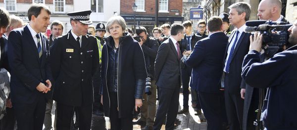 Britain's Prime Minister Theresa May, centre, is briefed by members of the police as she views the area where former Russian double agent Sergei Skripal and his daughter were found critically ill, in Salisbury, England, Thursday, March 15, 2018 - Sputnik International