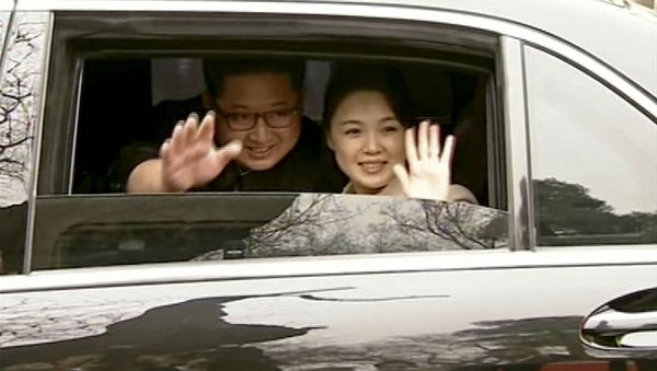 In this image taken from video footage run Wednesday, March 28, 2018, by China's CCTV via AP Video, North Korean leader Kim Jong Un, left, and his wife Ri Sol Ju wave from a car as they bid farewell to Chinese counterpart Xi Jinping and his wife Peng Liyuan in Beijing. North Korea's leader Kim and his Chinese counterpart Xi sought to portray strong ties between the neighbors and long-time allies despite a recent chill, as both countries on Wednesday confirmed Kim's secret trip to Beijing this week. In this image taken from video footage run Wednesday, March 28, 2018, by China's CCTV via AP Video, North Korean leader Kim Jong Un, left, and his wife Ri Sol Ju wave from a car as they bid farewell to Chinese counterpart Xi Jinping and his wife Peng Liyuan in Beijing. North Korea's leader Kim and his Chinese counterpart Xi sought to portray strong ties between the neighbors and long-time allies despite a recent chill, as both countries on Wednesday confirmed Kim's secret trip to Beijing this week. - Sputnik International