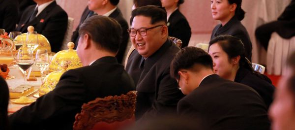 North Korean leader Kim Jong Un smiles during a banquet, as he paid an unofficial visit to Beijing, China, in this undated photo released by North Korea's Korean Central News Agency (KCNA) in Pyongyang March 28, 2018. - Sputnik International