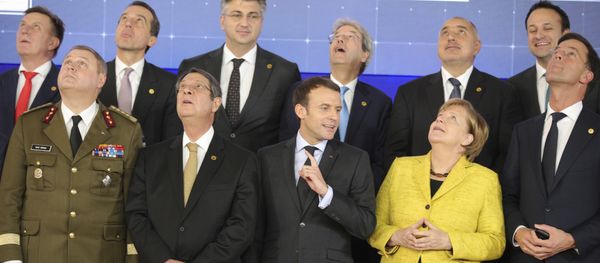 French President Emmanuel Macron, front center, speaks with German Chancellor Angela Merkel, front second right, as they look up at a drone flying above their heads during a group photo at an EU summit at the Europa building in Brussels on Thursday, Dec. 14, 2017 French President Emmanuel Macron, front center, speaks with German Chancellor Angela Merkel, front second right, as they look up at a drone flying above their heads during a group photo at an EU summit at the Europa building in Brussels on Thursday, Dec. 14, 2017 - Sputnik International