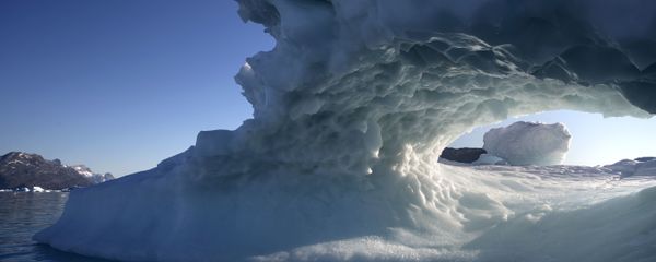 The sun sets through a hole melted in an iceberg floating in the Nuup Kangerlua Fjord near Nuuk in southwestern Greenland, Tuesday Aug. 1, 2017. The sun sets through a hole melted in an iceberg floating in the Nuup Kangerlua Fjord near Nuuk in southwestern Greenland, Tuesday Aug. 1, 2017. - Sputnik International