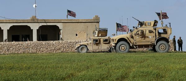 In this picture taken Thursday, March 29, 2018, U.S. soldiers, left, sit on a house that turned to an outpost on a road leading to the tense front line between U.S-backed Syrian Manbij Military Council fighters and Turkish-backed fighters, at Halawanji village, north of Manbij town, Syria In this picture taken Thursday, March 29, 2018, U.S. soldiers, left, sit on a house that turned to an outpost on a road leading to the tense front line between U.S-backed Syrian Manbij Military Council fighters and Turkish-backed fighters, at Halawanji village, north of Manbij town, Syria - Sputnik International
