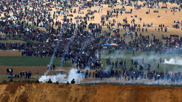 Israeli soldiers shoot tear gas from the Israeli side of the Israel-Gaza border, as Palestinians protest on the Gaza side of the border, March 30, 2018 Israeli soldiers shoot tear gas from the Israeli side of the Israel-Gaza border, as Palestinians protest on the Gaza side of the border, March 30, 2018 - Sputnik International