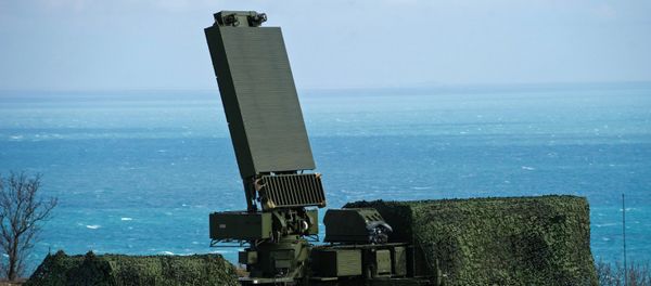 The all-altitude radar (center) and anti-aircraft missile containers (left) of the S-400 Triumph air defense regiment. File photo - Sputnik International