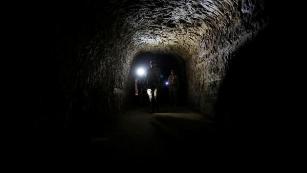 A member of Syrian forces of President Bashar al Assad walks inside a tunnel that was used by rebels in Jobar, eastern Ghouta, in Damascus, Syria April 2, 2018 A member of Syrian forces of President Bashar al Assad walks inside a tunnel that was used by rebels in Jobar, eastern Ghouta, in Damascus, Syria April 2, 2018 - Sputnik International