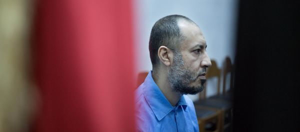Saadi Muammar Gadhafi, wears a blue jumpsuit behind bars during his trial in the center of Tripoli, Libya, Sunday, Nov. 1, 2015. - Sputnik International