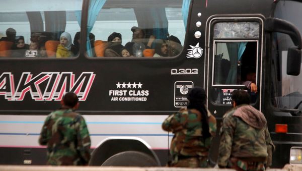 Syrian rebels and civilians look through a bus window as they leave Harasta in eastern Ghouta, in Damascus, Syria March 23, 2018 - Sputnik International