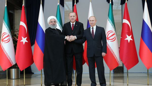 Russian President Vladimir Putin, Turkish President Recep Tayyip Erdogan and Iranian President Hassan Rouhani, right to left, pose for a photo before a meeting in Ankara Russian President Vladimir Putin, Turkish President Recep Tayyip Erdogan and Iranian President Hassan Rouhani, right to left, pose for a photo before a meeting in Ankara - Sputnik International