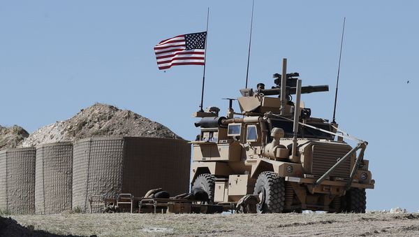 A U.S. soldier sits on an armored vehicle on a newly installed position, near the tense front line between the U.S-backed Syrian Manbij Military Council and the Turkish-backed fighters, in Manbij, north Syria, Wednesday, April 4, 2018 A U.S. soldier sits on an armored vehicle on a newly installed position, near the tense front line between the U.S-backed Syrian Manbij Military Council and the Turkish-backed fighters, in Manbij, north Syria, Wednesday, April 4, 2018 - Sputnik International