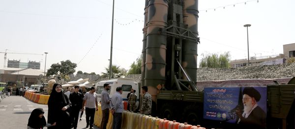 People walk past a Russian-made S-300 air defence system displayed on Baharestan square in Tehran on September 25, 2017 - Sputnik International