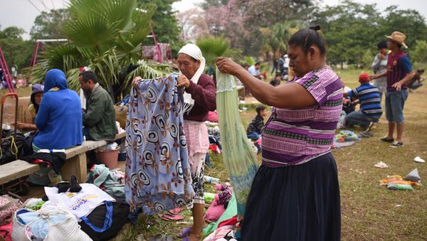 Central American migrants taking part in the Migrant Via Crucis caravan towards the United States pack their belongings as they prepare to leave a sport complex where they were camping in Matias Romero, Oaxaca State, Mexico Central American migrants taking part in the Migrant Via Crucis caravan towards the United States pack their belongings as they prepare to leave a sport complex where they were camping in Matias Romero, Oaxaca State, Mexico - Sputnik International