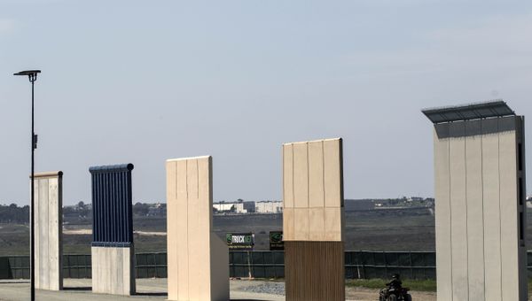 A US border patrol quad is seen next to US President Donald Trump's border wall prototypes from Tijuana, northwestern Mexico - Sputnik International