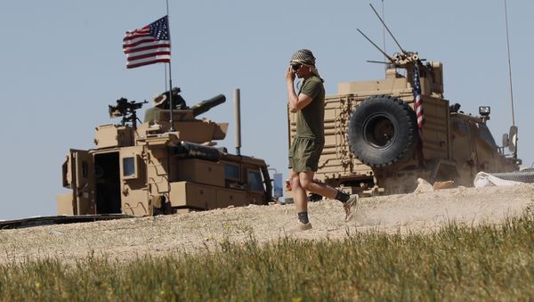 A US soldier walks on a newly installed position, near the tense front line between the US-backed Syrian Manbij Military Council and the Turkish-backed fighters, in Manbij, north Syria, April 4, 2018 A US soldier walks on a newly installed position, near the tense front line between the US-backed Syrian Manbij Military Council and the Turkish-backed fighters, in Manbij, north Syria, April 4, 2018 - Sputnik International