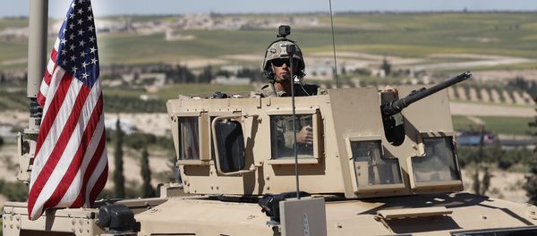 A US soldier sits in an armored vehicle on a road leading to the tense front line with Turkish-backed fighters, in Manbij, north Syria, Wednesday, April 4, 2018 A US soldier sits in an armored vehicle on a road leading to the tense front line with Turkish-backed fighters, in Manbij, north Syria, Wednesday, April 4, 2018 - Sputnik International