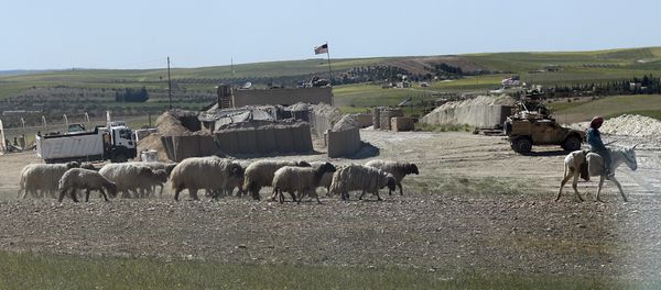 A Syrian shepherd herds his flock, as he passes in front of a newly installed U.S. position near the tense front line between the U.S-backed Syrian Manbij Military Council and the Turkish-backed fighters, in Manbij, north Syria, Wednesday, April 4, 2018 A Syrian shepherd herds his flock, as he passes in front of a newly installed U.S. position near the tense front line between the U.S-backed Syrian Manbij Military Council and the Turkish-backed fighters, in Manbij, north Syria, Wednesday, April 4, 2018 - Sputnik International