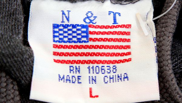 The label of a Washington D.C. sweatshirt bears a U.S. flag but says Made in China at a souvenir stand in Washington, DC, U.S., January 14, 2011 The label of a Washington D.C. sweatshirt bears a U.S. flag but says Made in China at a souvenir stand in Washington, DC, U.S., January 14, 2011 - Sputnik International