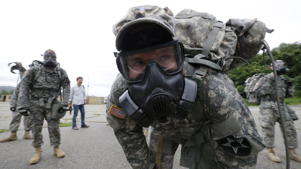 A soldiers of the U.S. Army 23rd chemical battalion wearing a gas mask rests after a competition at Camp Stanley in Uijeongbu, South Korea, Wednesday, July 8, 2015 - Sputnik International