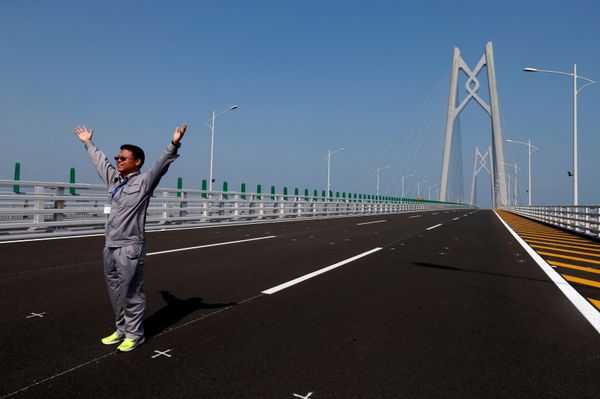 A man poses on a section of the Hong Kong-Zhuhai-Macau Bridge, to be opened in Zhuhai, China March 28, 2018 A man poses on a section of the Hong Kong-Zhuhai-Macau Bridge, to be opened in Zhuhai, China March 28, 2018 - Sputnik International