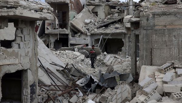 A man stands on rubble of damaged buildings in the besieged town of Douma, Eastern Ghouta, in Damascus, Syria March 30, 2018 A man stands on rubble of damaged buildings in the besieged town of Douma, Eastern Ghouta, in Damascus, Syria March 30, 2018 - Sputnik International