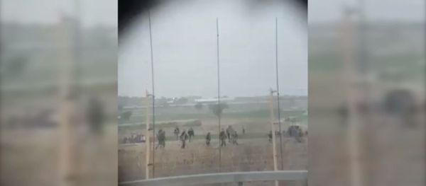 Palestinian protesters rush to aid a man struck by sniper fire from the Israeli Defense Forces at a November 22 protest. Palestinian protesters rush to aid a man struck by sniper fire from the Israeli Defense Forces at a November 22 protest. - Sputnik International