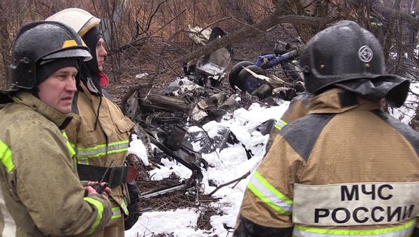 Emergencies Ministry rescuers at the crash site of a Mil Mi-8 helicopter that had a rough landing killing six people. A screenshot from a video provided by the Russian Emergencies Ministry - Sputnik International