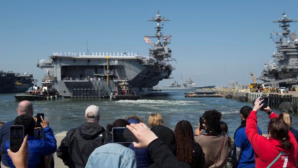 Family members look on as the U.S. Navy aircraft carrier USS Harry S. Truman departs with its carrier strike group towards the Middle East from Naval Station Norfolk, Virginia, U.S. April 11, 2018 - Sputnik International