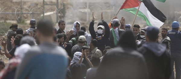 Palestinian protesters chant slogans as they gather during a protest at the Gaza Strip's border with Israel, Friday, April 13, 2018 Palestinian protesters chant slogans as they gather during a protest at the Gaza Strip's border with Israel, Friday, April 13, 2018 - Sputnik International