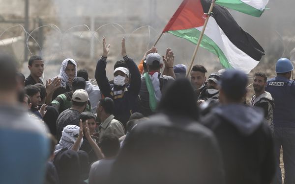 Palestinian protesters chant slogans as they gather during a protest at the Gaza Strip's border with Israel, Friday, April 13, 2018 Palestinian protesters chant slogans as they gather during a protest at the Gaza Strip's border with Israel, Friday, April 13, 2018 - Sputnik International
