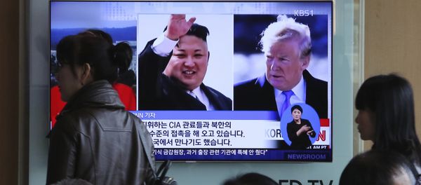 People pass by a TV screen showing file footages of U.S. President Donald Trump, right, and North Korean leader Kim Jong Un during a news program at the Seoul Railway Station in Seoul, South Korea, Monday, April 9, 2018 - Sputnik International