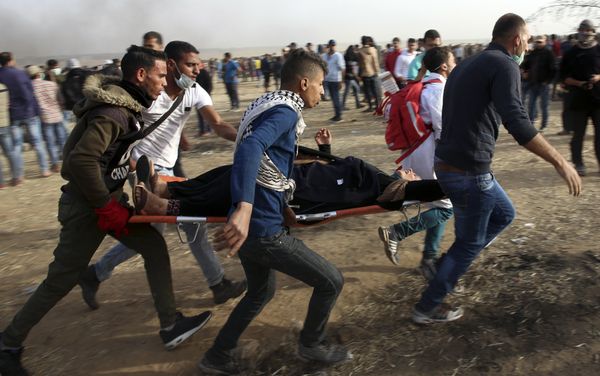 Palestinian protesters evacuate a wounded woman during clashes with Israeli troops along Gaza's border with Israel, Friday, April 13, 2018. Palestinian protesters evacuate a wounded woman during clashes with Israeli troops along Gaza's border with Israel, Friday, April 13, 2018. - Sputnik International