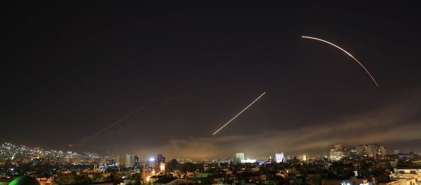Missiles streak across the Damascus skyline as the U.S. launches an attack on Syria targeting different parts of the capital, early Saturday, April 14, 2018. Syria's capital has been rocked by loud explosions that lit up the sky with heavy smoke as U.S. President Donald Trump announced airstrikes in retaliation for the country's alleged use of chemical weapons. Missiles streak across the Damascus skyline as the U.S. launches an attack on Syria targeting different parts of the capital, early Saturday, April 14, 2018. Syria's capital has been rocked by loud explosions that lit up the sky with heavy smoke as U.S. President Donald Trump announced airstrikes in retaliation for the country's alleged use of chemical weapons. - Sputnik International