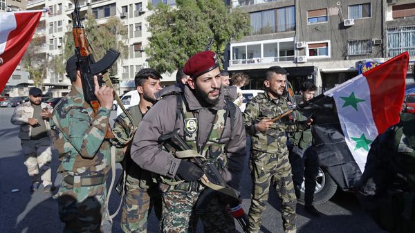 Syrian soldier wave weapons and national flags as they chant slogans against U.S. President Trump during demonstrations following a wave of U.S., British and French military strikes to punish President Bashar Assad for suspected chemical attack against civilians, in Damascus, Syria, Saturday, April 14, 2018 Syrian soldier wave weapons and national flags as they chant slogans against U.S. President Trump during demonstrations following a wave of U.S., British and French military strikes to punish President Bashar Assad for suspected chemical attack against civilians, in Damascus, Syria, Saturday, April 14, 2018 - Sputnik International