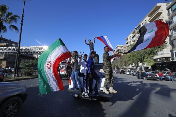 Syrian government supporters wave Syrian, Iranian and Russian flags as they chant slogans against US President Trump during demonstrations following a wave of US, British and French military strikes to punish President Bashar Assad for suspected chemical attack against civilians, in Damascus, Syria, Saturday, April 14, 2018. Syrian government supporters wave Syrian, Iranian and Russian flags as they chant slogans against US President Trump during demonstrations following a wave of US, British and French military strikes to punish President Bashar Assad for suspected chemical attack against civilians, in Damascus, Syria, Saturday, April 14, 2018. - Sputnik International