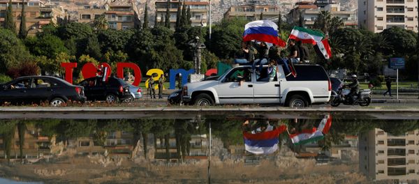 Syrian government supporters chant slogans against U.S. President Trump during demonstrations following a wave of U.S., British and French military strikes to punish President Bashar Assad for suspected chemical attack against civilians, in Damascus, Syria, Saturday, April 14, 2018 Syrian government supporters chant slogans against U.S. President Trump during demonstrations following a wave of U.S., British and French military strikes to punish President Bashar Assad for suspected chemical attack against civilians, in Damascus, Syria, Saturday, April 14, 2018 - Sputnik International