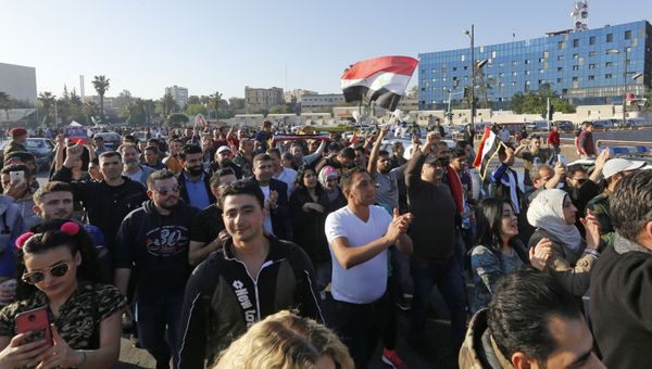 Syrians wave the national flag and wave portraits of President Bashar al-Assad as they gather at the Umayyad Square in Damascus on April 14, 2018, to condemn the strikes carried out by the United States, Britain and France against the Syrian regime Syrians wave the national flag and wave portraits of President Bashar al-Assad as they gather at the Umayyad Square in Damascus on April 14, 2018, to condemn the strikes carried out by the United States, Britain and France against the Syrian regime - Sputnik International