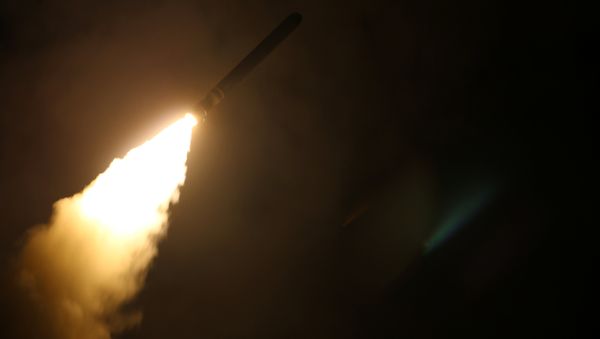 The U.S. Navy guided-missile cruiser USS Monterey fires a Tomahawk land attack missile April 14, 2018 - Sputnik International