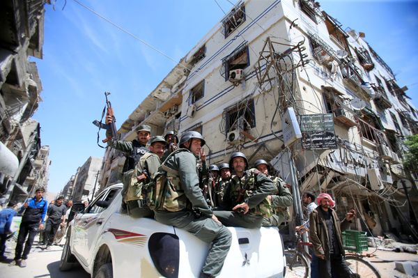 Members of the Syrian police hold their weapons as they sit on a back of a truck at the city of Douma, Damascus, Syria April 16, 2018 Members of the Syrian police hold their weapons as they sit on a back of a truck at the city of Douma, Damascus, Syria April 16, 2018 - Sputnik International