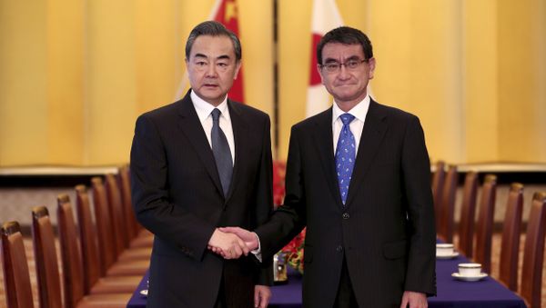 Japanese Foreign Minister Taro Kono, right, and his Chinese counterpart Wang Yi, left, shake hands ahead of their meeting in Tokyo Japanese Foreign Minister Taro Kono, right, and his Chinese counterpart Wang Yi, left, shake hands ahead of their meeting in Tokyo - Sputnik International