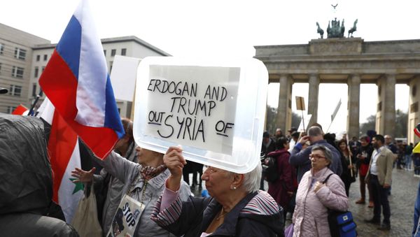 (File) A protester holds a poster during the demonstration against airstrikes on Syria in Berlin, Germany April 14, 2018 (File) A protester holds a poster during the demonstration against airstrikes on Syria in Berlin, Germany April 14, 2018 - Sputnik International