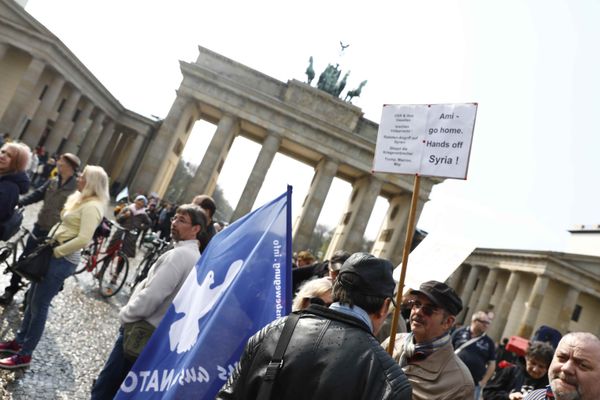 A protester holds a poster during the demonstration against airstrikes on Syria in Berlin, Germany - Sputnik International