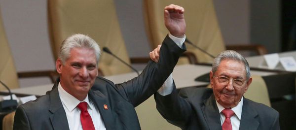 Cuba's outgoing President Raul Castro, right, and new President Miguel Diaz-Canel raise their arms in unison at the National Assembly in Havana, Cuba, Thursday, April 19, 2018. - Sputnik International