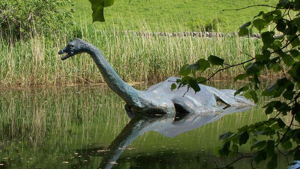 In this June 2006 file photo a model monster replica of the legendary sea serpent of Loch Ness, Nessie, provides a photo op for visitors in Drumnadrochit, Scotland - Sputnik International
